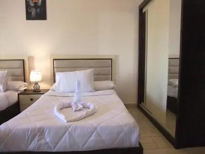 a bedroom with a bed with a towel on it at Sky Relax ALDAU HEIGHTS in Hurghada
