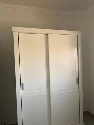 a closet with white doors in a room at Villa Muhammad in Quseir