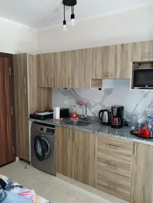 a kitchen with a sink and a stove top oven at Studiowohnung auf Poolebene in Hurghada