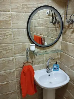 a bathroom with a sink and a mirror at Studiowohnung auf Poolebene in Hurghada