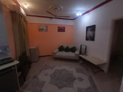 a living room with a couch and a ceiling fan at ALHASANI APARTMENT in Hurghada