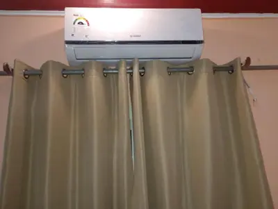 a air conditioner and a printer on top of a shower curtain at ALHASANI APARTMENT in Hurghada