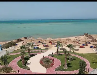 an aerial view of a beach with umbrellas and the ocean at Kazpilkna Beach Neighborhoods in Hurghada