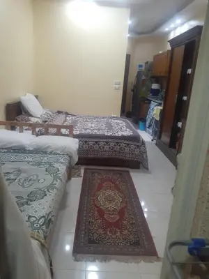 three beds in a room with three rugs on the floor at Kazpilkna Beach Neighborhoods in Hurghada