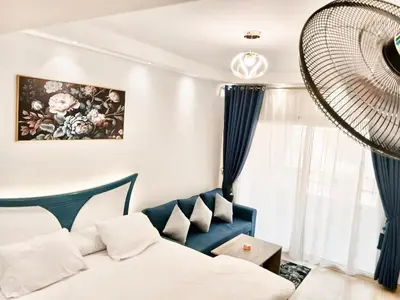 a hotel room with a bed and a fan at Florenza Khamsin Resort Hurghada in Hurghada