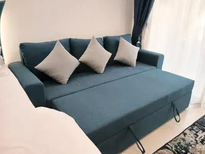 a blue couch with pillows in a living room at Florenza Khamsin Resort Hurghada in Hurghada