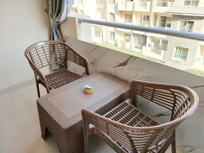two chairs and a table on a balcony at Florenza Khamsin Resort Hurghada in Hurghada