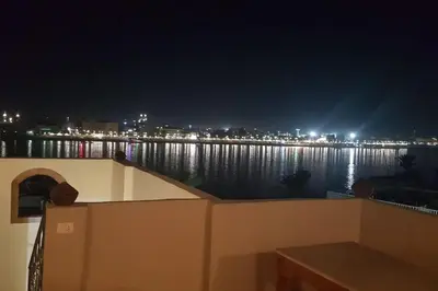 a view of the water at night at Elminaa Residents 2 in Luxor