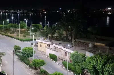 a view of a building with a street at night at El Minaa Residents 5 in Luxor