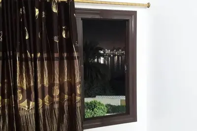 a window with a curtain in a room at El Minaa Residents 5 in Luxor