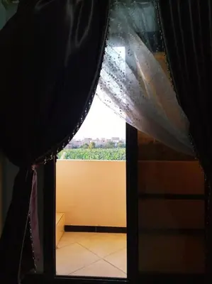 a view of a window with a curtain at El Minaa Residents 5 in Luxor