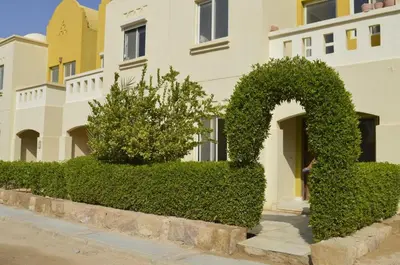 a row of bushes in front of a building at Nice 2-Bed Apartment in Hurghada
