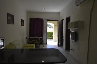 a living room with a couch and a tv and a table at Nice 2-Bed Apartment in Hurghada