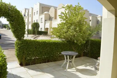 a stool sitting on a sidewalk in front of a building at Nice 2-Bed Apartment in Hurghada