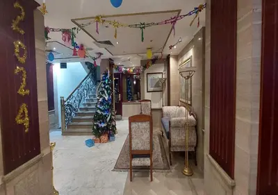 a living room with a christmas tree and a staircase at Emilio Hotel in Luxor
