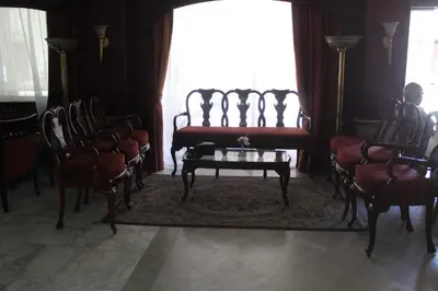 a room with chairs and a bench and a table at Emilio Hotel in Luxor