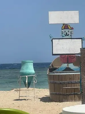 a barrel and a sign on the beach at Ziena marvel camp in Quseir