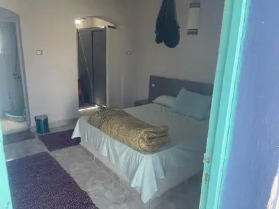 a bedroom with a bed with a blanket on it at Ziena marvel camp in Quseir