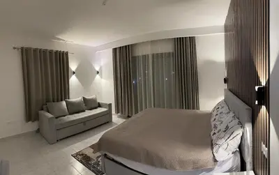 a bedroom with a bed and a couch at Apartment with services Stella Beach Resort 5 star Makadi bay Egypt in Hurghada