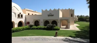 a large house with a green lawn in front of it at Apartment with services Stella Beach Resort 5 star Makadi bay Egypt in Hurghada