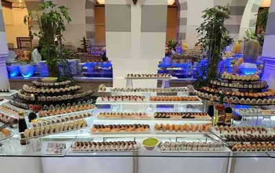 a buffet with many different types of cakes on display at Apartment with services Stella Beach Resort 5 star Makadi bay Egypt in Hurghada