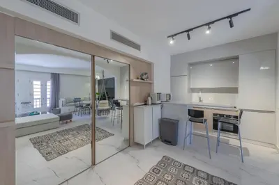 a kitchen with a living room and a dining room at Stylish Nest - New Marina - El Gouna in Hurghada