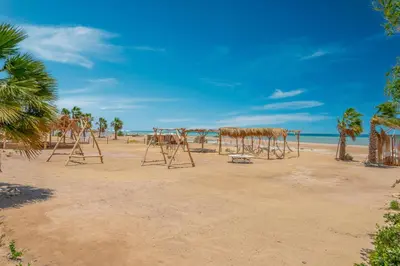 a group of wooden structures on the beach at Stylish Nest - New Marina - El Gouna in Hurghada