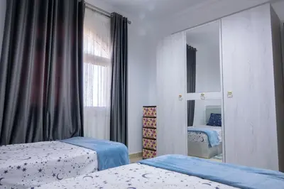 a bedroom with two beds and a mirror at Beautiful 2-Bed Villa in Makadi Heights in Hurghada