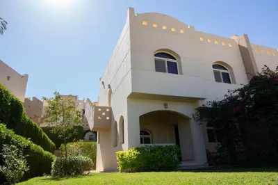 a large white house with a green yard at Beautiful 2-Bed Villa in Makadi Heights in Hurghada