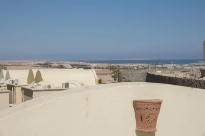 a vase on the side of a wall with a view of a city at Beautiful 2-Bed Villa in Makadi Heights in Hurghada
