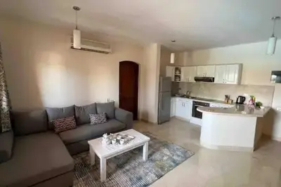 a living room with a couch and a table at Vue magnifique, confort unique in Hurghada