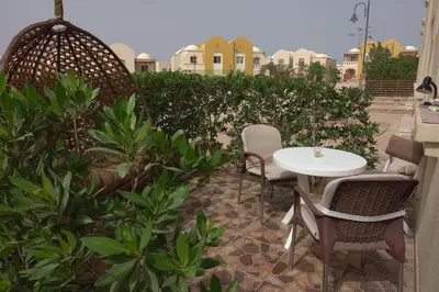 a patio with a table and chairs and plants at Captivating 1-Bed Apartment in hurghada in Hurghada
