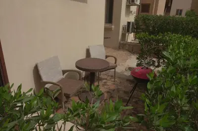 three chairs and a table and a table and chairs at Captivating 1-Bed Apartment in hurghada in Hurghada