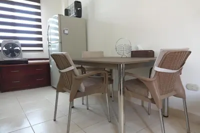 a dining room table with chairs and a refrigerator at Captivating 1-Bed Apartment in hurghada in Hurghada