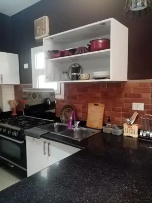 a kitchen with a sink and a stove top oven at Family-friendly apartments in Hurghada in Hurghada