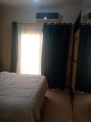 a bedroom with a bed and a window with curtains at Family-friendly apartments in Hurghada in Hurghada