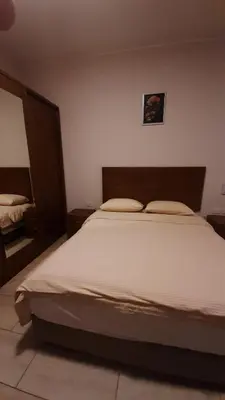 a bedroom with a large white bed with two pillows at Hurghada Aldau Heights Studio in Hurghada