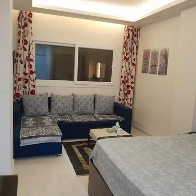 a living room with a couch and a bed at selena bay resort in Hurghada
