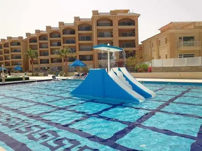 a slide in the middle of a swimming pool at selena bay resort in Hurghada