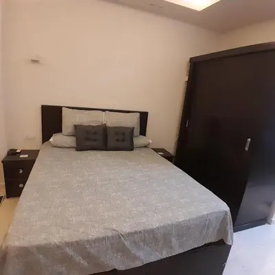 a bedroom with a large bed and two night stands at selena bay resort in Hurghada