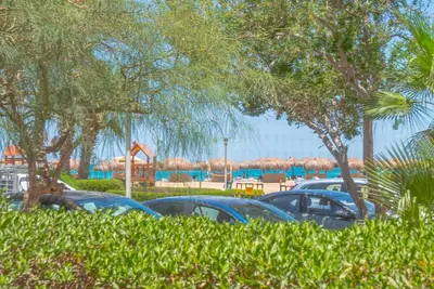 a group of cars parked in a parking lot with umbrellas at Beach Front Paradise - 3 master beds - Abu Tig Marina - El Gouna in Hurghada