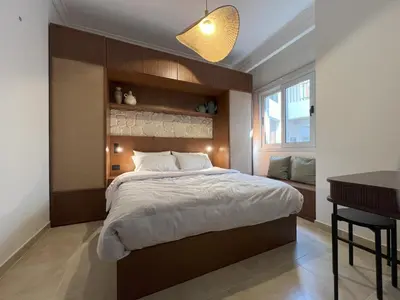 a bedroom with a large bed and a desk at Casa De Madera - 1BR Sea & Golf View - Soma Bay in Hurghada
