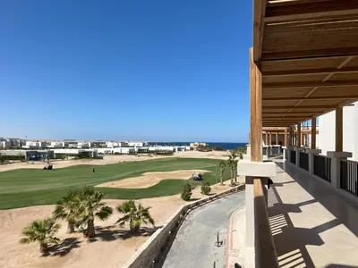 a view of the golf course from the balcony of a resort at Casa De Madera - 1BR Sea & Golf View - Soma Bay in Hurghada