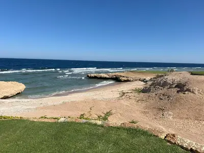 a beach with the ocean in the background at Casa De Madera - 1BR Sea & Golf View - Soma Bay in Hurghada