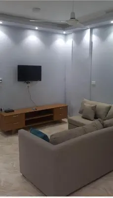 a living room with a couch and a flat screen tv at Ikea flat 8 in Hurghada
