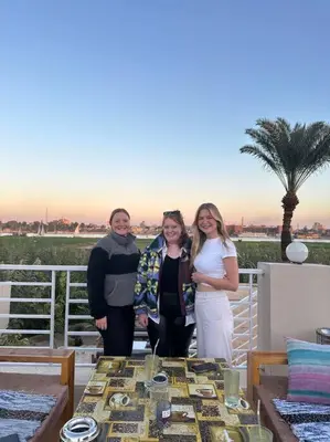 a group of people standing next to a table at Royal Nile Suites - Luxury Nile View 2 in Luxor