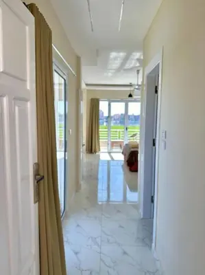 a hallway with a door leading to a living room at Royal Nile Suites - Luxury Nile View 2 in Luxor