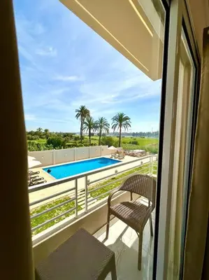 a balcony with a view of a swimming pool at Royal Nile Suites - Luxury Nile View 2 in Luxor