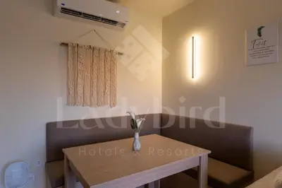 a dining room with a table and a window at Ladybird - Veranda Highline in Hurghada