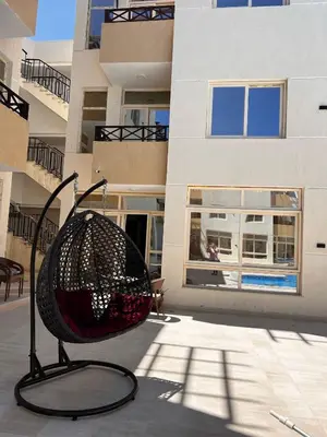 a chair sitting in front of a building at Port Ghalib Apartments in Port Ghalib